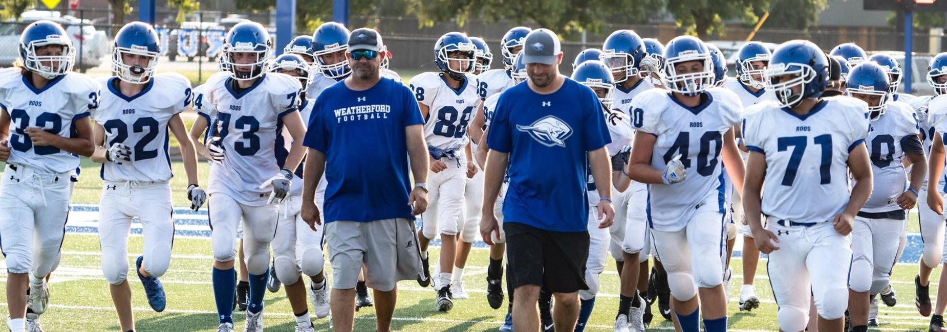 Freshman football team entering the field