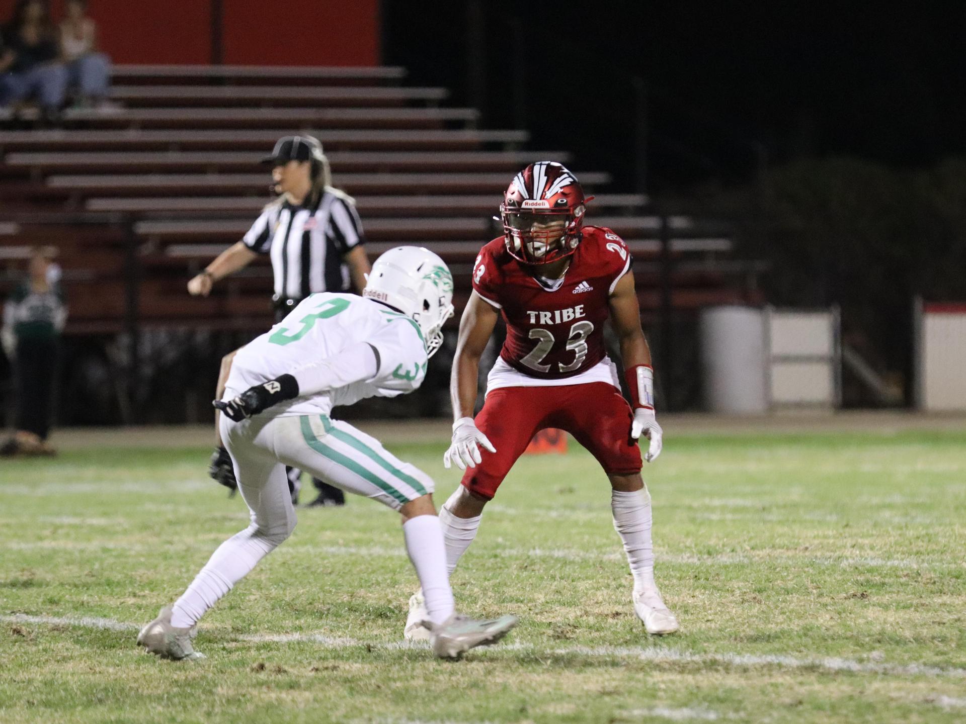 varsity football players in action against Riverdale