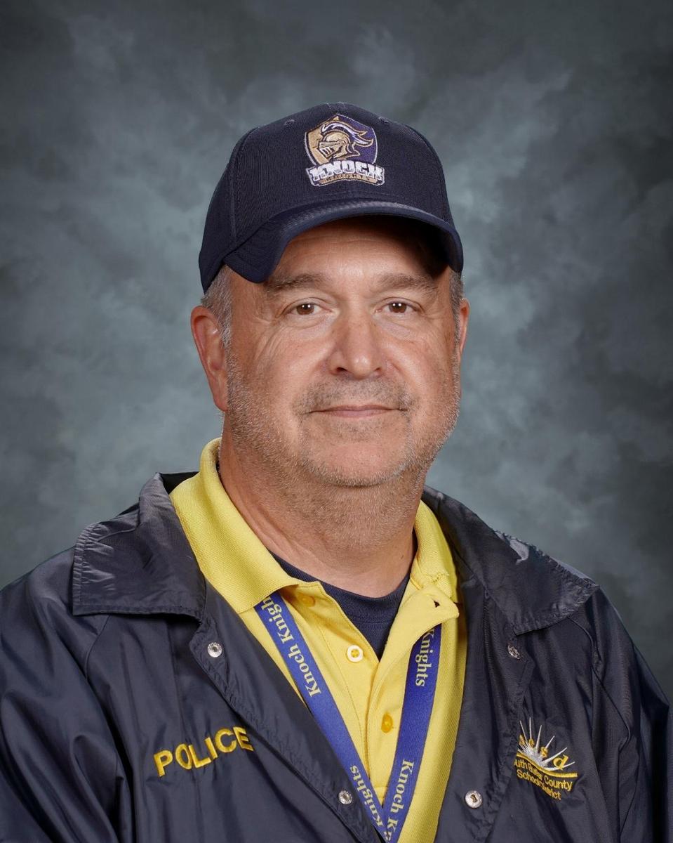 Pat Sarnese wearing police jacket, yellow shirt and navy hat