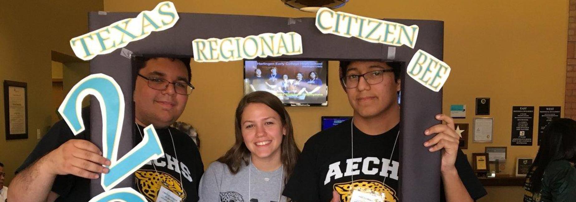 Students holding up a picture frame