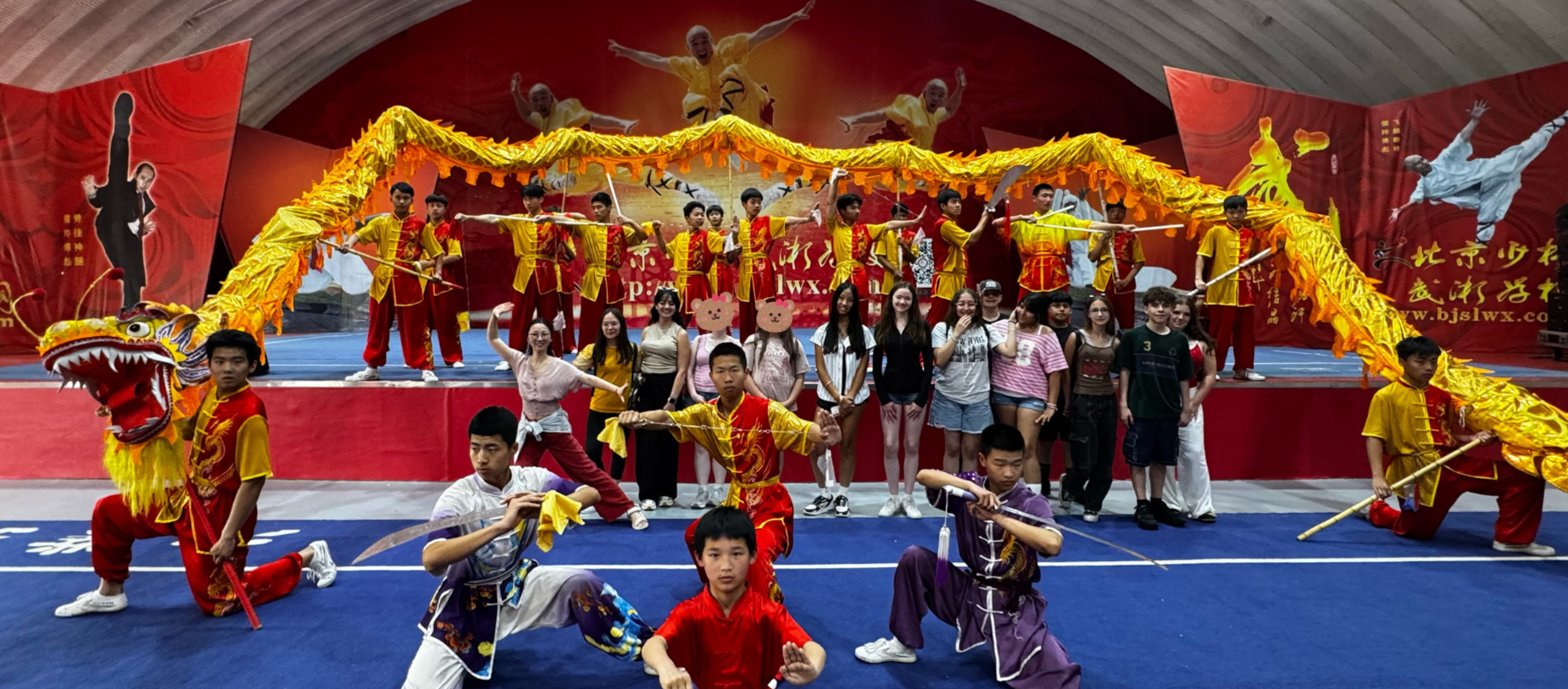Participants in colorful costumes pose with a dragon and perform martial arts.