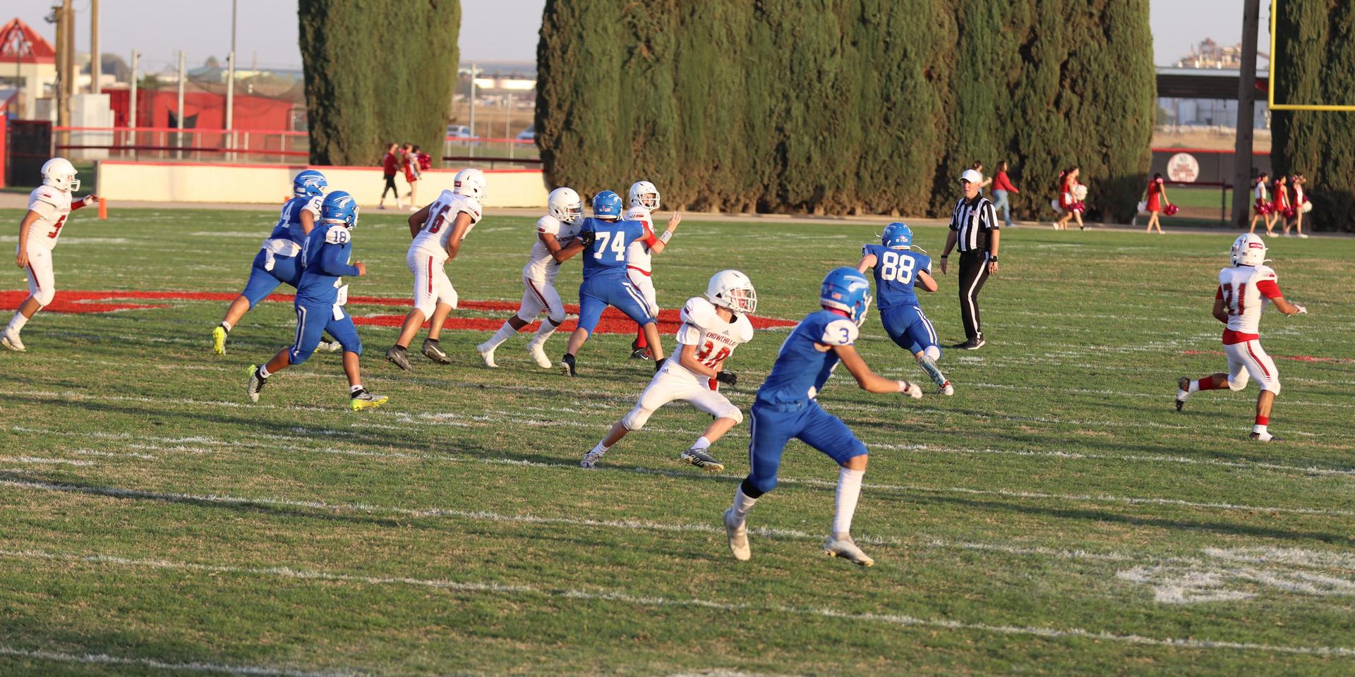 Junior Varsity football players in action against Caruthers