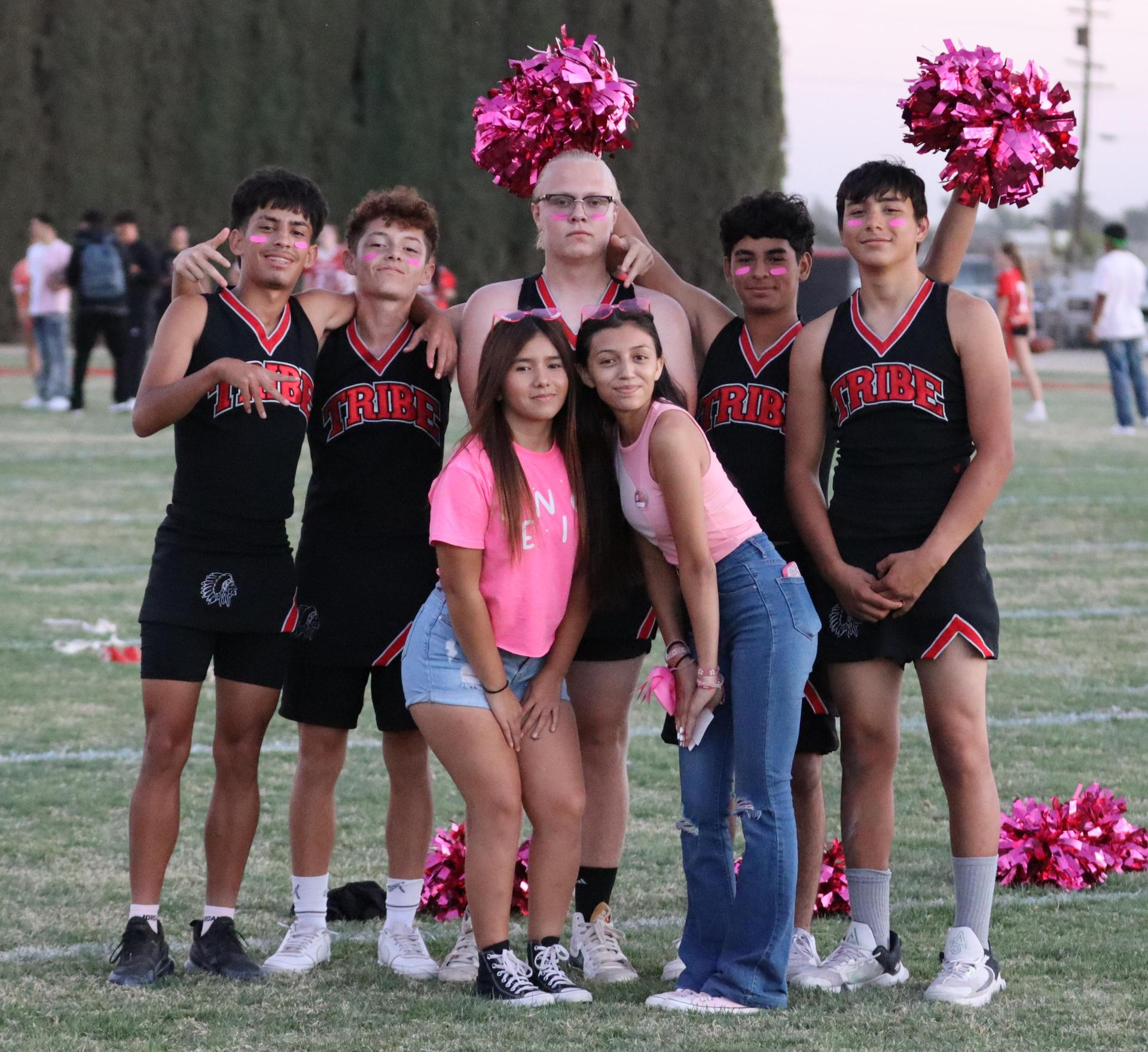 players, cheerleaders, and officials preparing for the powderpuff football game