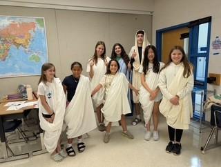 World Language camp photos of kids in togas