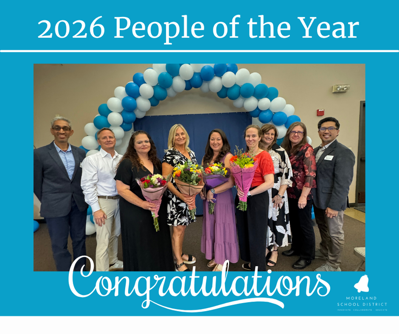 Award winners and board members in front of balloons