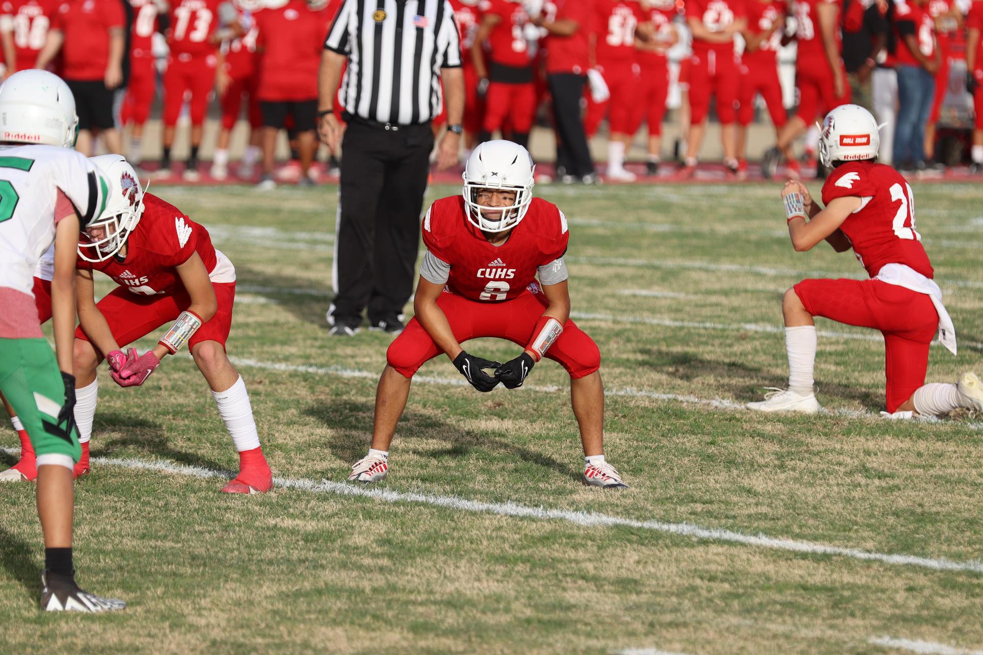  junior varsity football players in action against riverdale