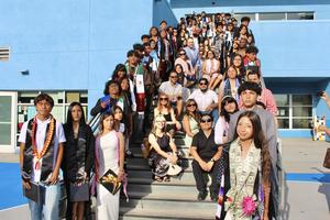 8th grade students stand together on stairs for photo