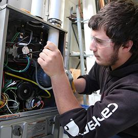 HVAC technician working on wiring