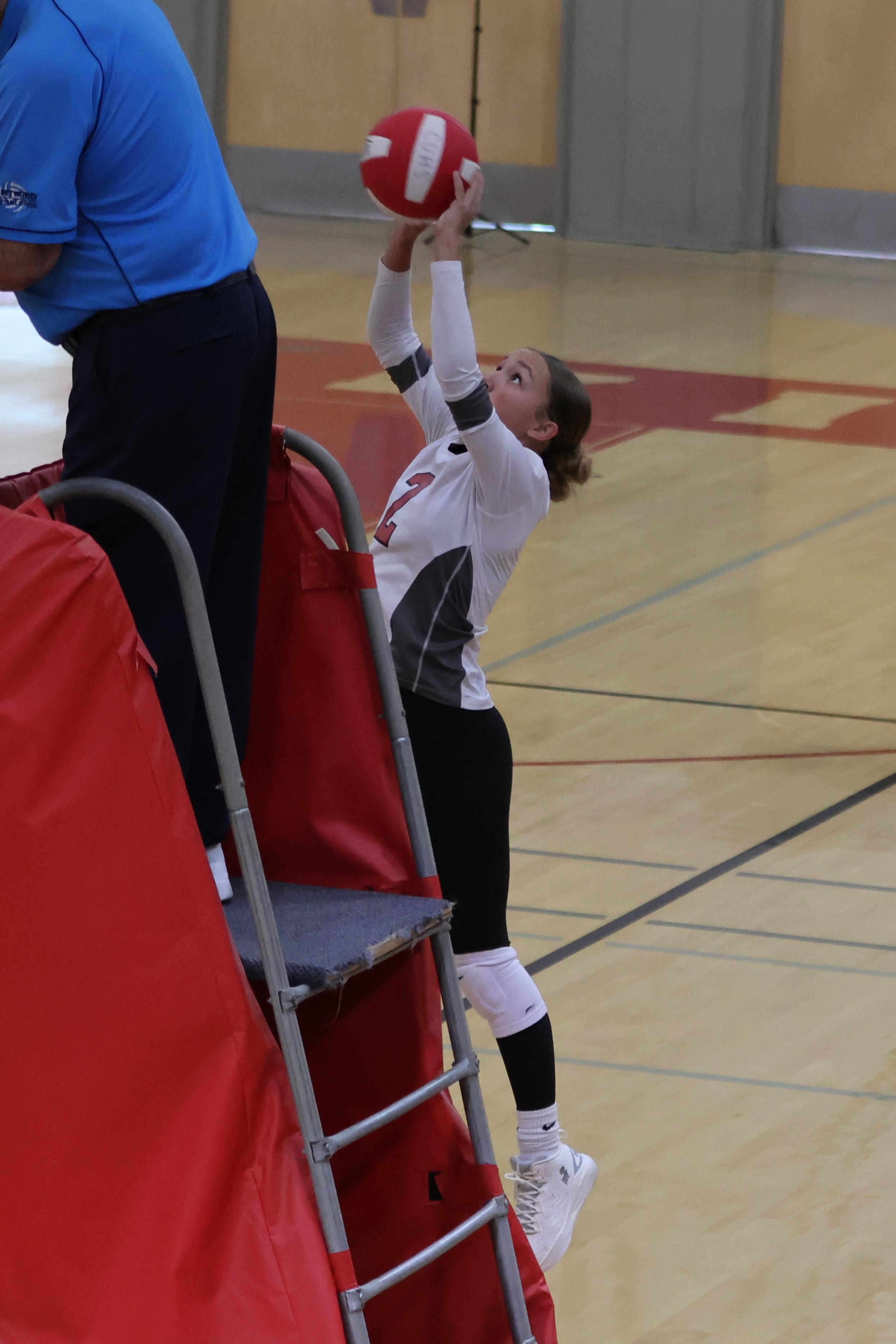 junior varsity girls playing volleyball 91