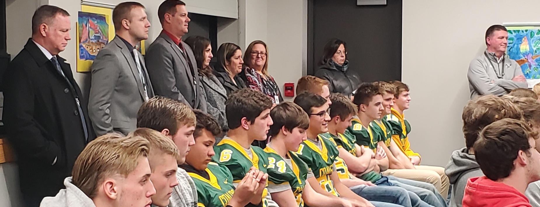 Honoring the football team at the board meeting