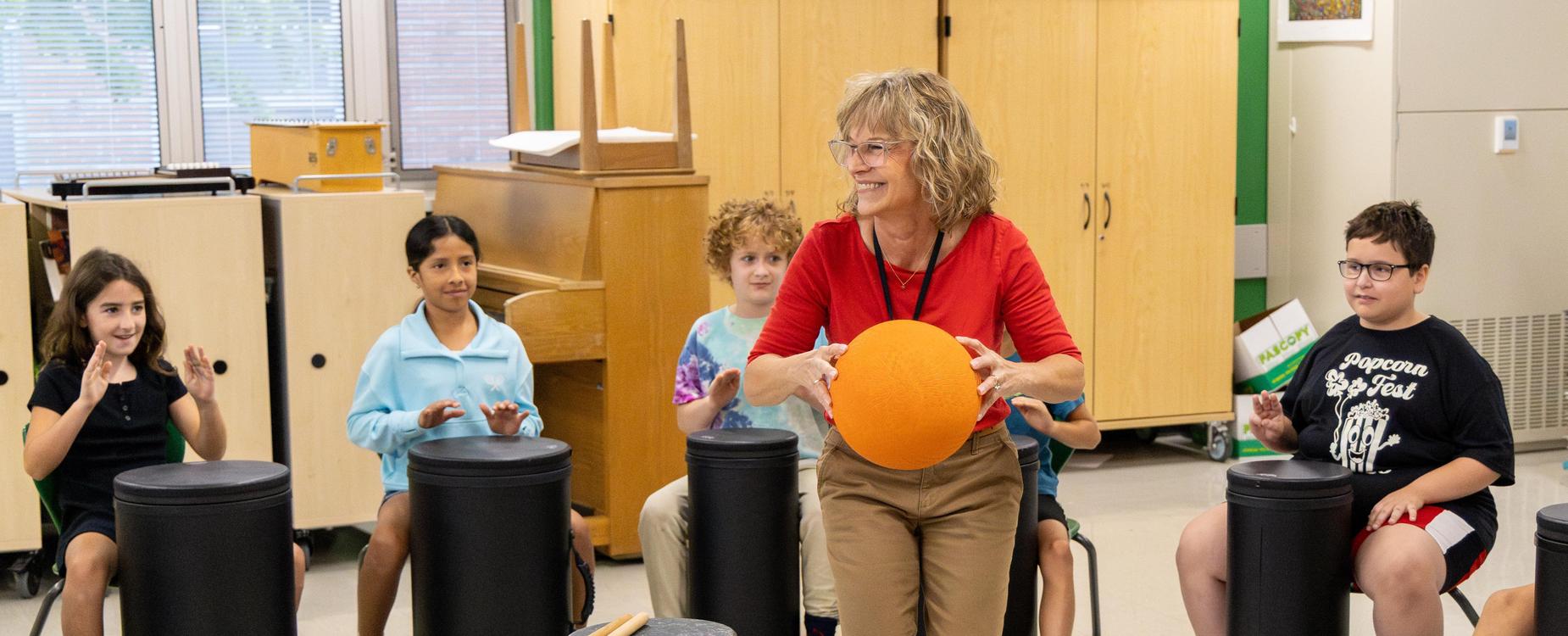 Students playing the drum in music class.