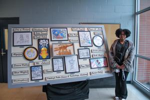 Keny'ce poses with the mural