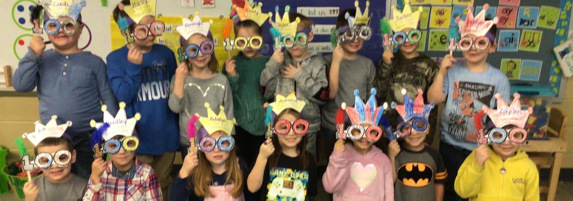 photo of Mrs. Powers' Kindergarten class with 100th day glasses and crowns