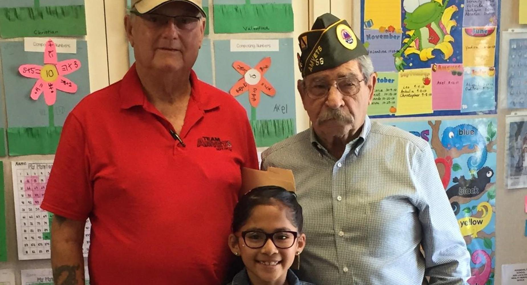 Roosevelt Student posing with two veterans.