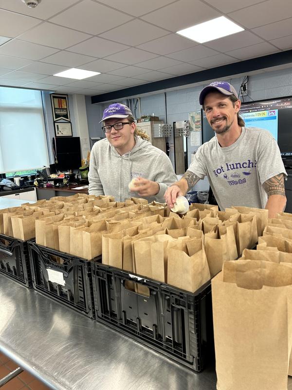 student and culinary instructor packing lunches