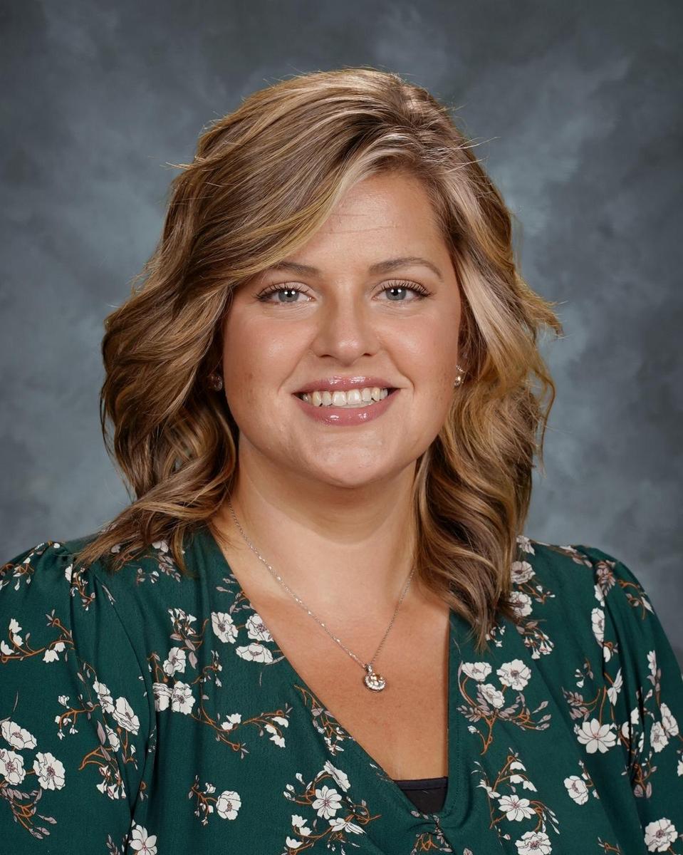 professional woman smiling with green top on
