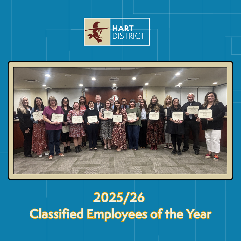 A group of classified employees and board members holding certificates and smiling.