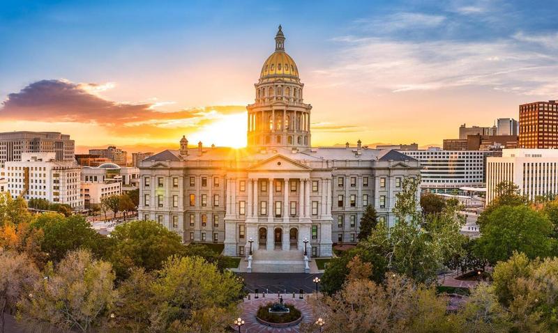 Legislative building in Denver, Colorado, with the sun setting behind it.