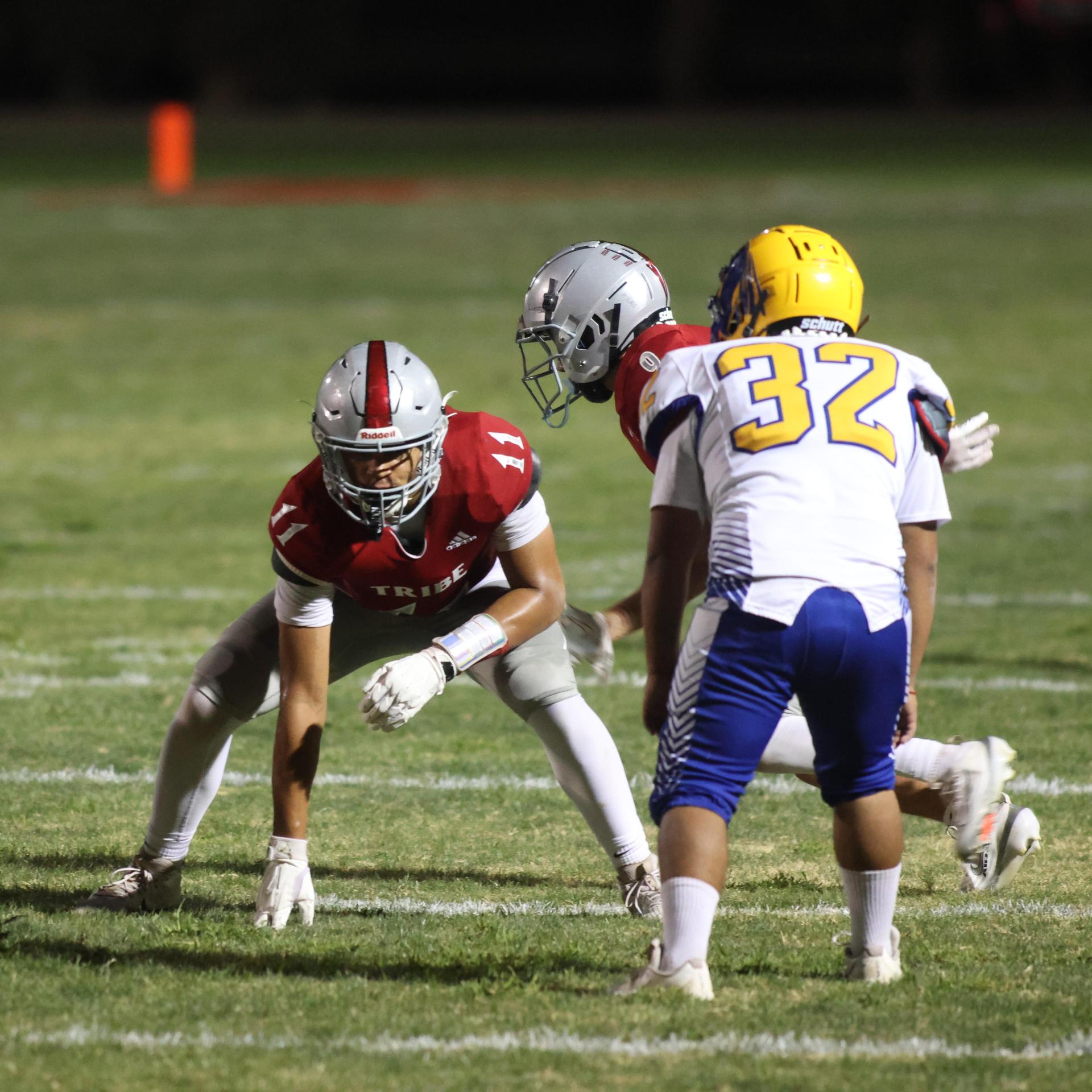Varsity football players in action against Parlier 148