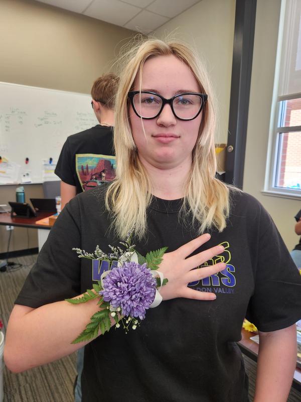 Kimber Heid holding her hand showing off the corsage she made.