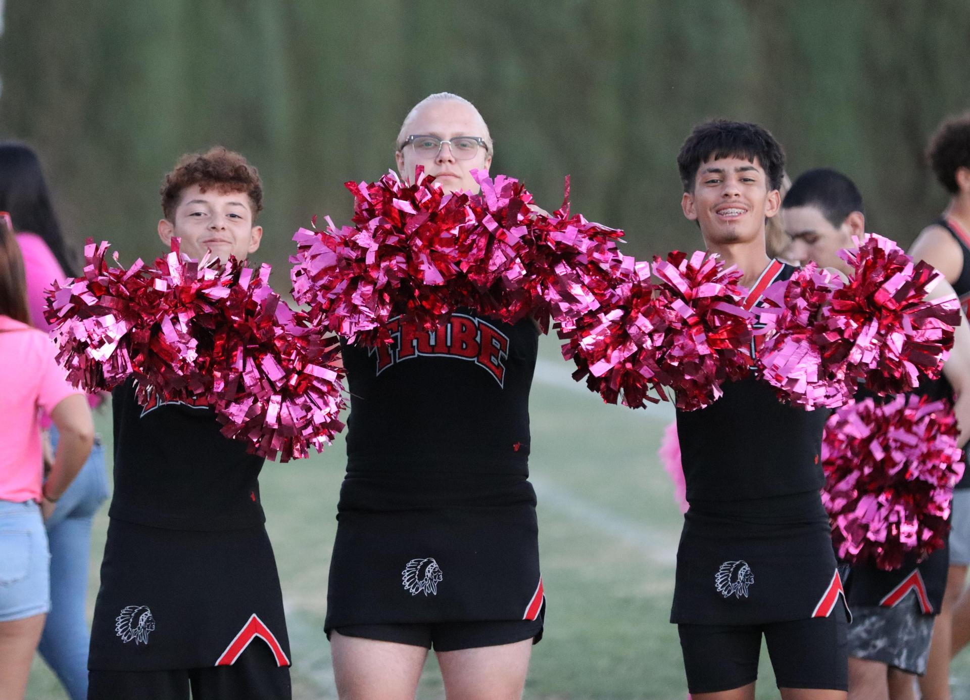 players, cheerleaders, and officials preparing for the powderpuff football game