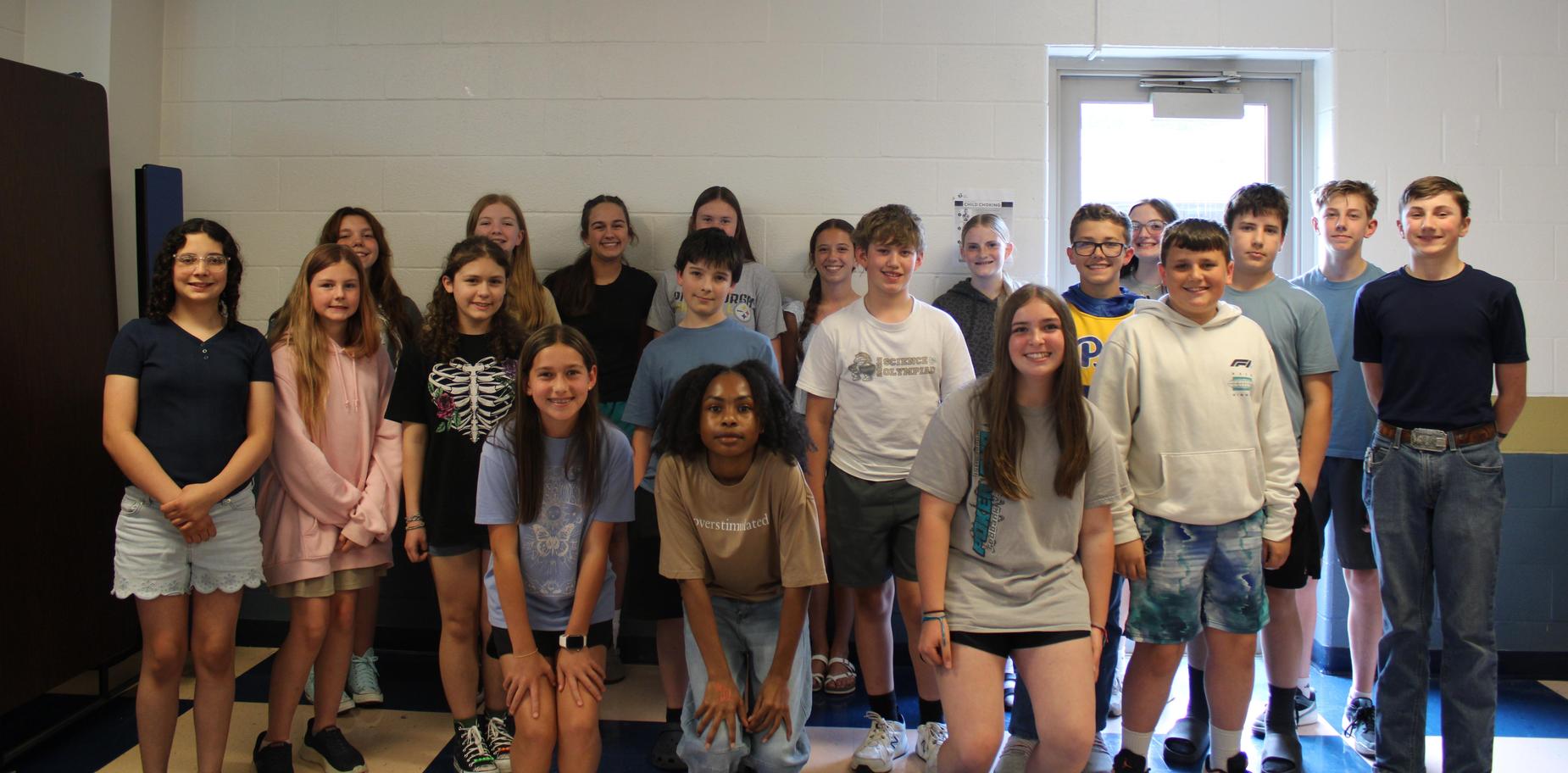 Group of students posing together in a classroom setting.