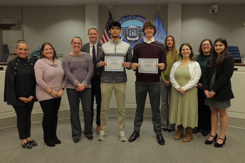 photo of school board members and two national merit semifinalists. also included is the superintedent and the student representative.