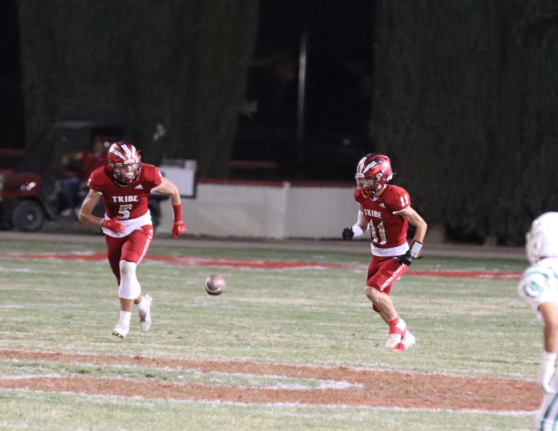 varsity football players in action against Riverdale