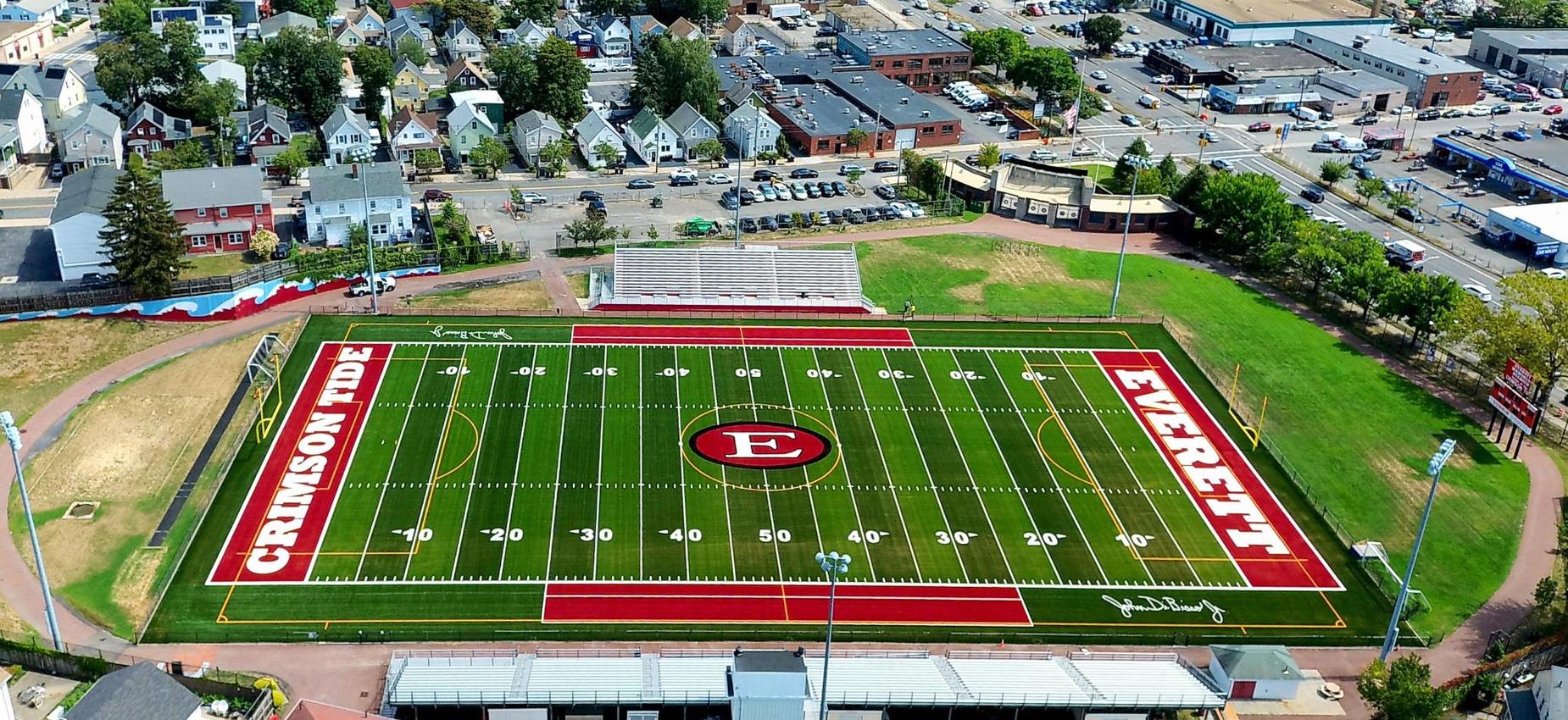 Aerial view of Everett city with football field and surrounding buildings.