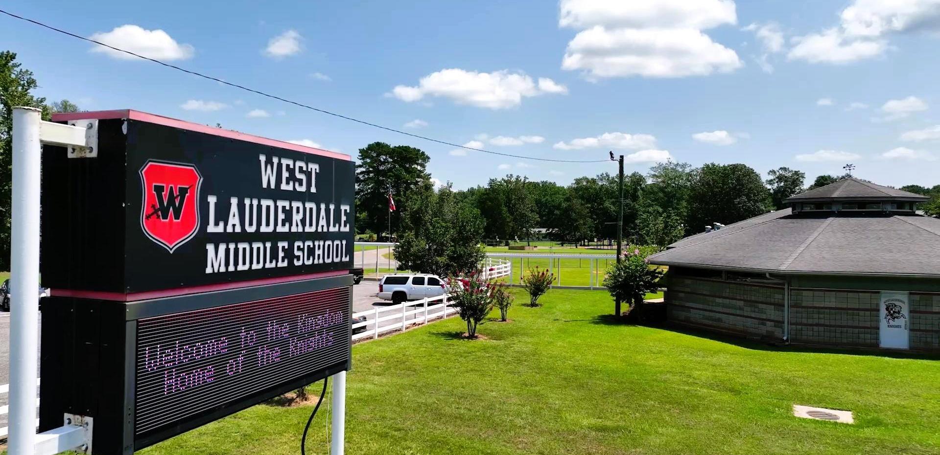Aerial view of West Lauderdale Middle School sign and surrounding grassy area.