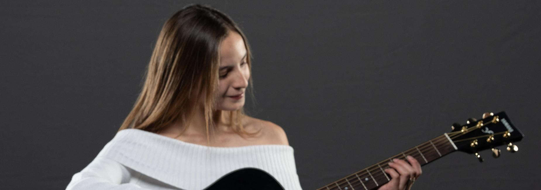 Student Playing Guitar