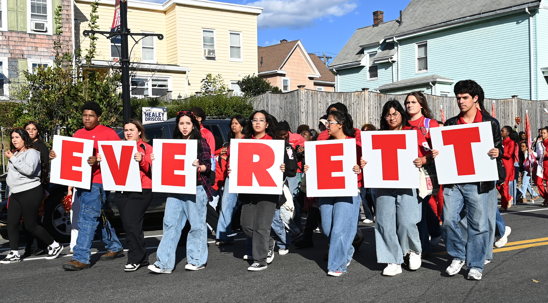 Students holding up signs that spell "Everett"