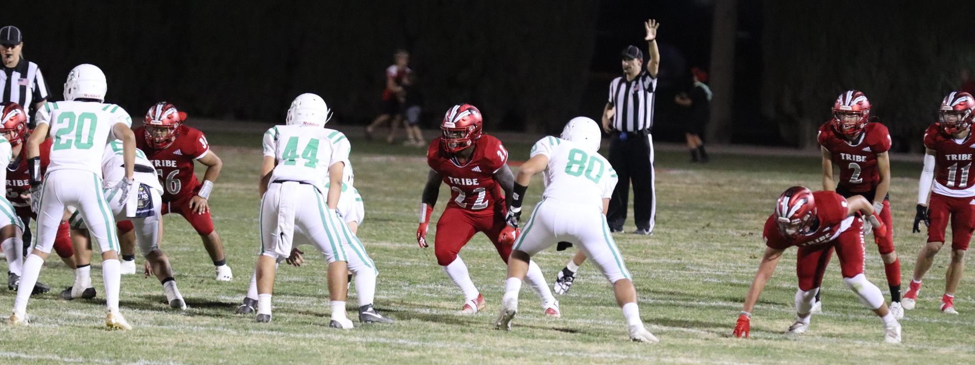 varsity football players in action against Riverdale