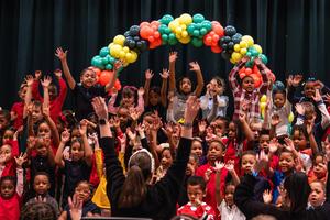 Kindergarten students sing at an assembly
