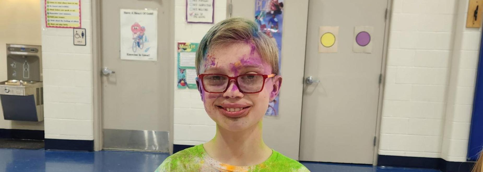 Boy covered in chalk from color run