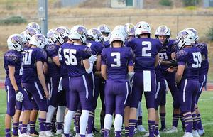 Football team huddles at midfield