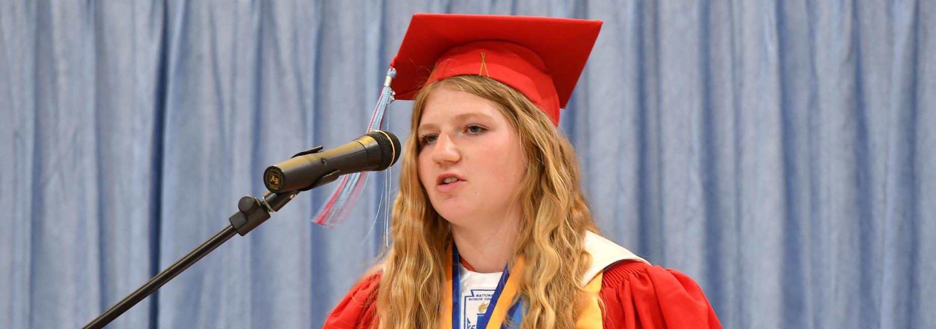 Student giving speech at graduation.