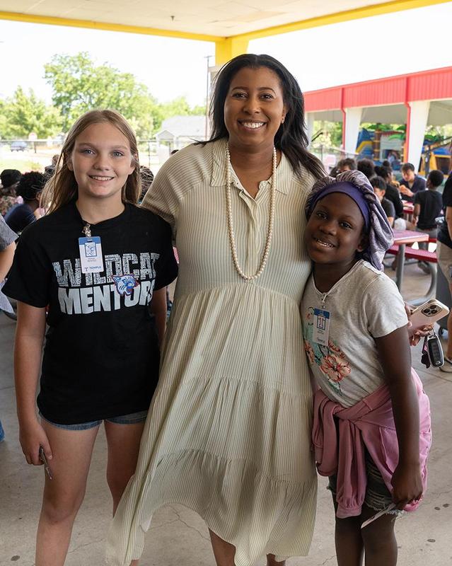 Wildcat Mentor board president Bre Alexander poses with two students