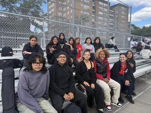 students with mixed expressions sitting on the bleachers