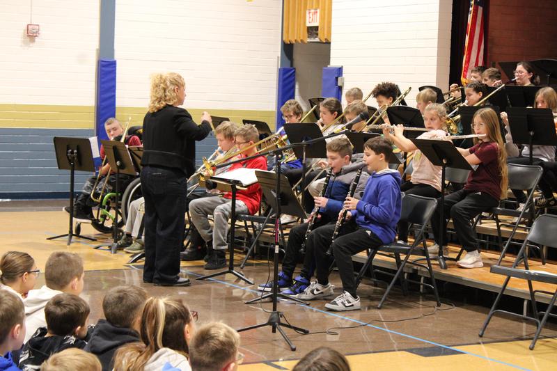 band director leading 5th grade band seated in front of her