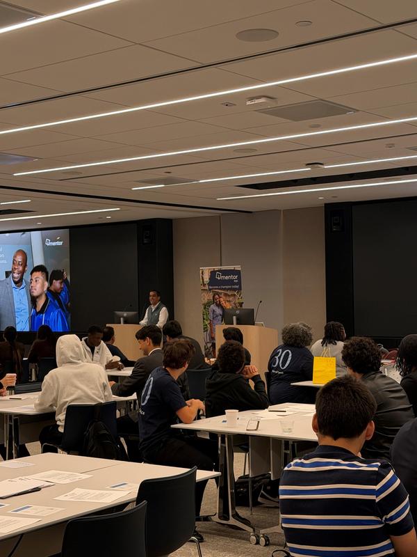 A classroom with students and a presenter discussing graduation.