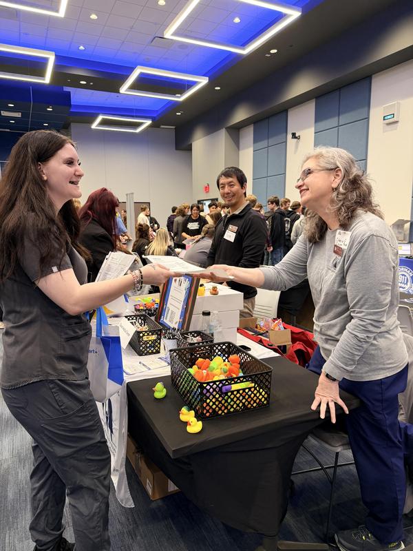 student shaking someone's hand at career fair