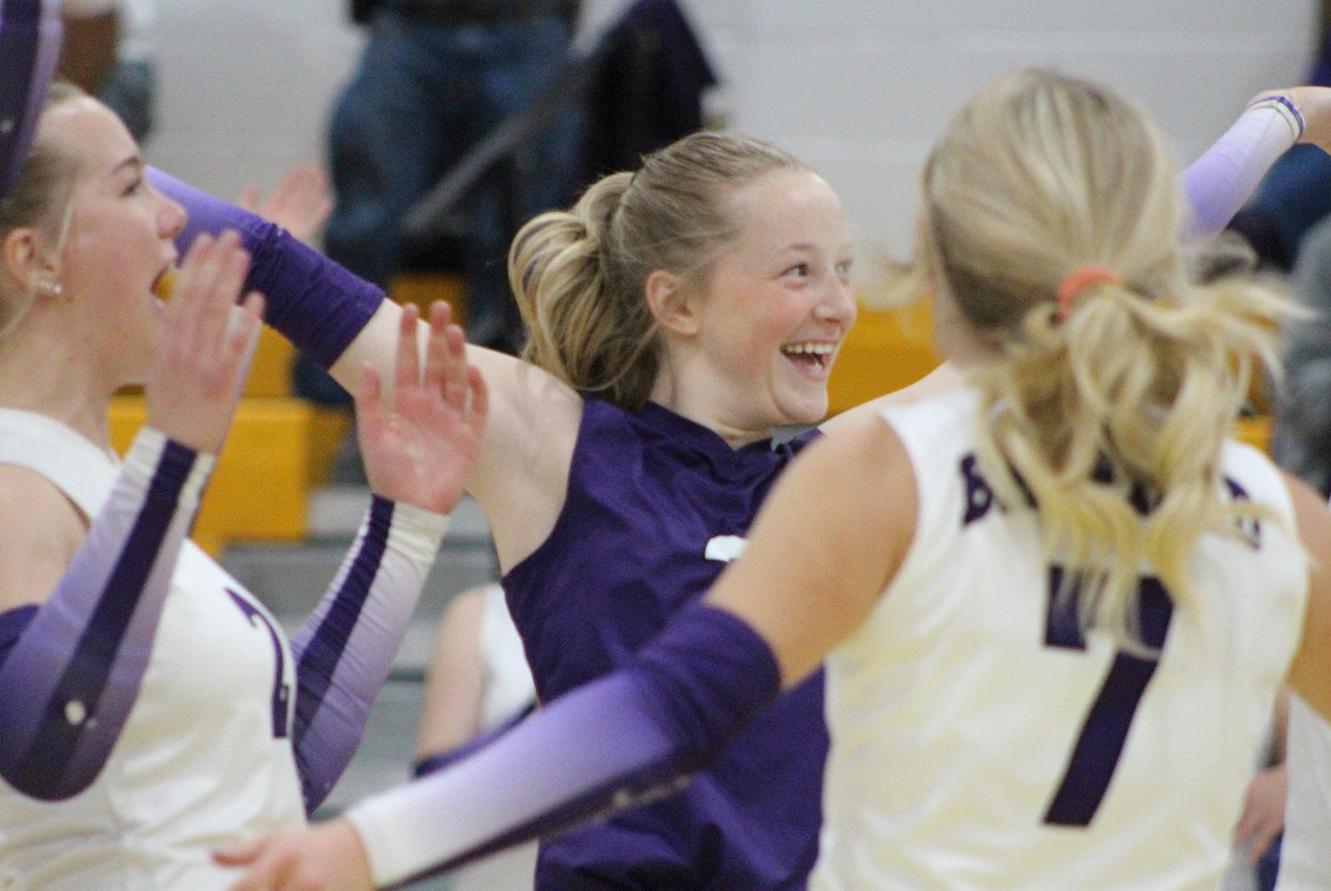 Volleyball players celebrate.
