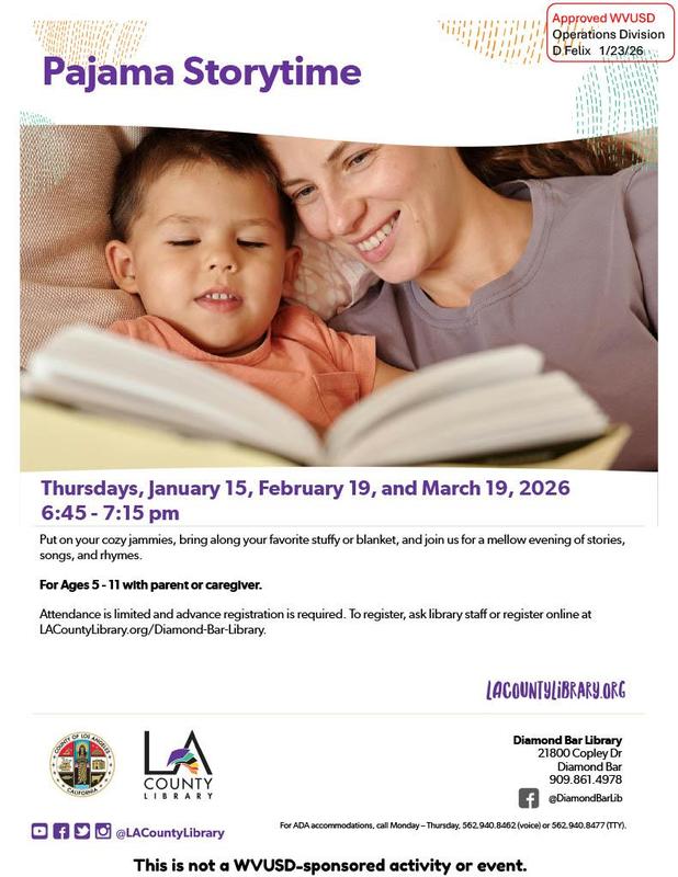 Child reading a book with an adult during a pajama storytime event at the library.