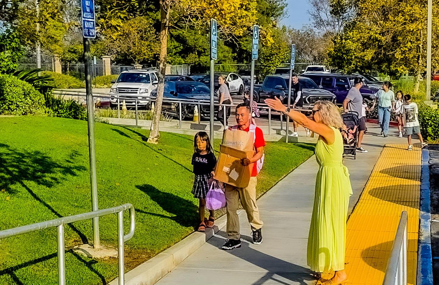Principal lemus with open arms greets parents