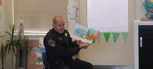 PD Officer reading to students at GB