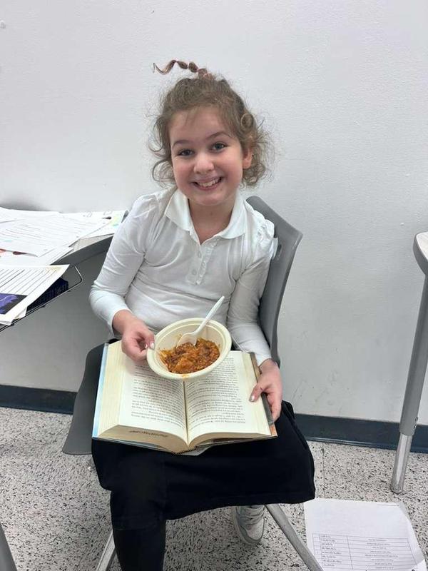 A student poses with her chulent.