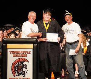 Austin Wiseman receives the Village Players scholarship from Mike and John Bremer.