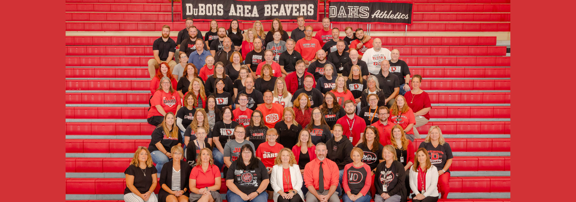 Group photo of DuBois Area High School staff red and black Beavers apparel on bleachers.