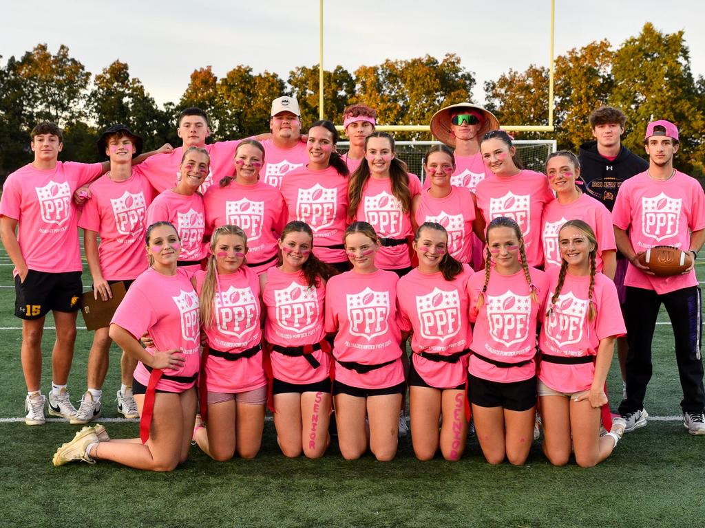 A group photo of the Flag Football Team in pink shirts.